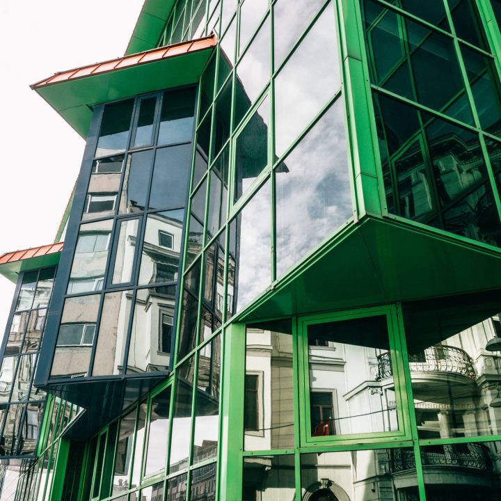 Green glass facade reflecting urban Istanbul architecture in a modern style.